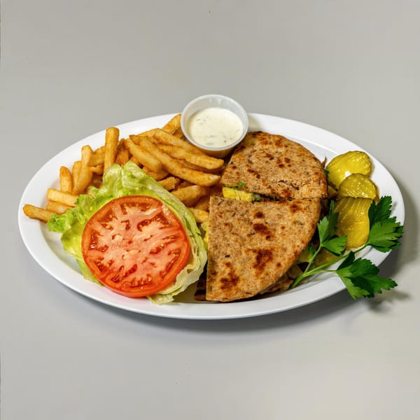 Cherry Pit Cafe's breakfast quesadilla with fries, lettuce, tomato, pickles, and a side of ranch.