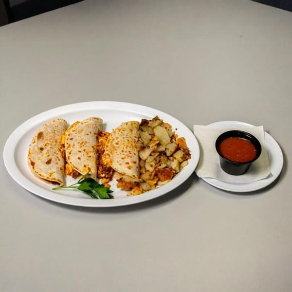 Breakfast quesadillas with scrambled eggs, home fries, and a side of salsa at Cherry Pit Cafe.
